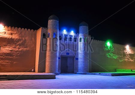 Medieval wall with a gate in the light colored lights