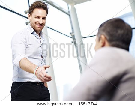 Businessman Reaching Out For A Handshake