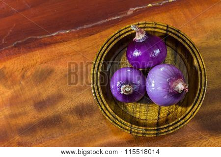 Red onion on wood background ready for cook