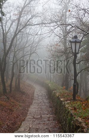 Stone Footpath And Street Lights In The Park.
