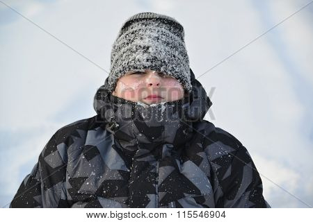 Portrait of frozen boy in winter