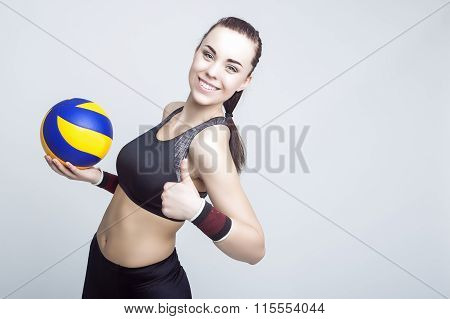 Sport Concepts And Ideas. Professional Female Volleyball Athlete With Ball Showing Thumbs Up Sign