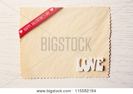 Blank present Valentine card on wooden background