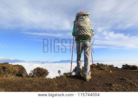 one young woman backpacker hiking on mountainpeak