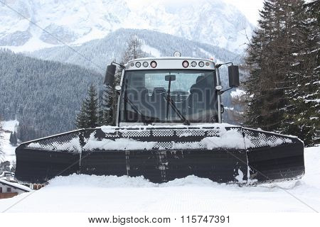 Dolomites skiing resort. Snowcat. Snow remover equipment.