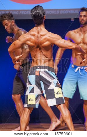 Male Fitness Model Shows His Physique In Swimsuit Om Stage