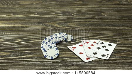 Poker Chips And Playing Cards On The Table. Focus On Cards