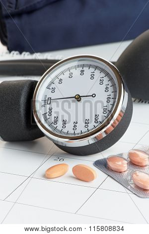 Tablets And Blood Pressure Meter On A Calendar