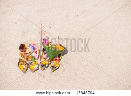 Balinese offering on the sandy beach