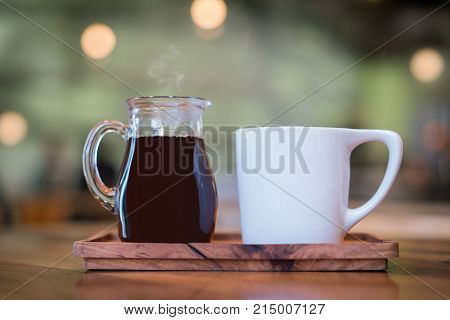 Fresh artisanal cafe hot coffee and mug close up