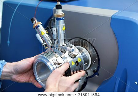 Adjust The Mass Spectrometer. The Man Analyzes The Device For Determining The Masses Of Atoms. Devic