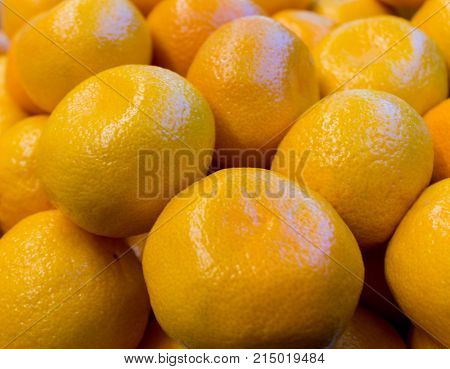 Fresh orange and yellow tangerines closeup close