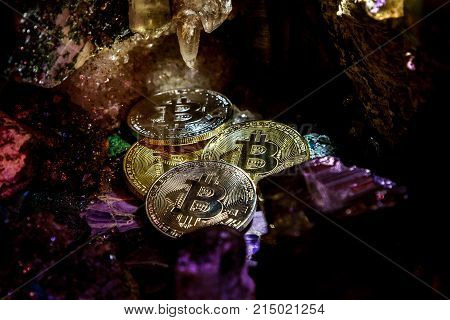 Silver and golden bitcoin in a cave of precious stones. Bitcoin cryptocurrency.