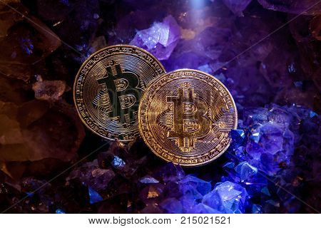 Silver and golden bitcoin in a cave of precious stones. Bitcoin cryptocurrency.