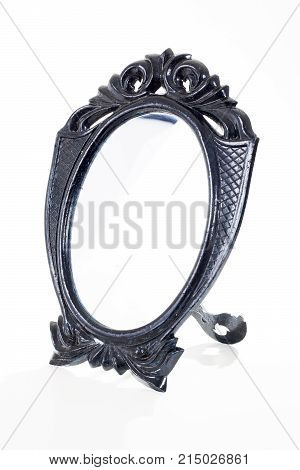 Black toy mirror On isolated white studio background. Clipping path. Single object on white background. Black cosmetic mirror with frame.