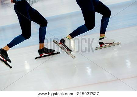 synchronous motion legs two athletes speed skaters on ice rink