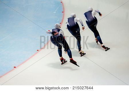 back women athletes speed skaters in warm up turn