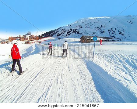 Paradiski, France - January 7, 2014: Ski resort slopes, skiers, mountain panorama in French Alps