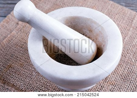 Mortar with pepper on a wooden board