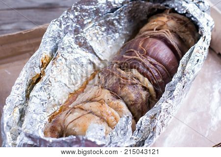 Roasted pork roll stuffed with vegetables and garlic