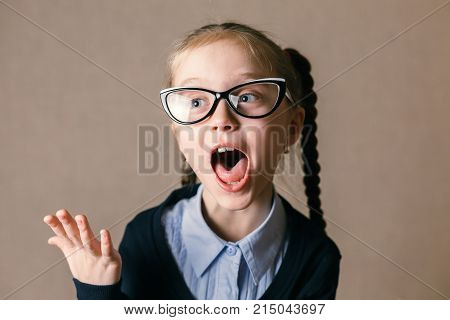 Funny screaming girl, studio shot. Educational concept