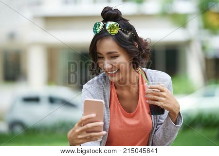 Beautiful Vietnamese girl smling when taking selfie outdoors