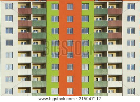 The facade of a typical block multi-storey residential building. Front view close up.