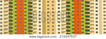 The facade of a typical block multi-storey residential building. Front view close up.