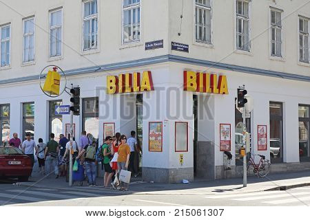 VIENNA AUSTRIA - JULY 11 2015: Shoppers in Front of Corner Market Billa Shop in Vienna Austria.