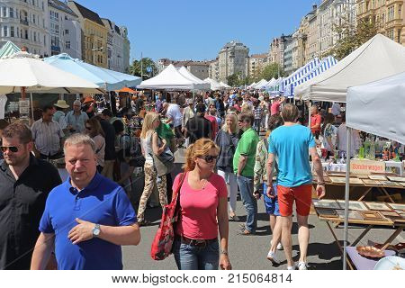 VIENNA AUSTRIA - JULY 11 2015: People Shopping at Naschmarkt Saturday Flea Market in Vienna Austria.