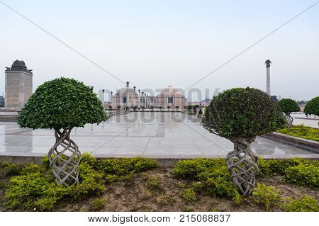 Beautiful artistic plants with the museum of Ambedkar park in teh background. The beutiful gardens of this landmark make it a popular hangout spot