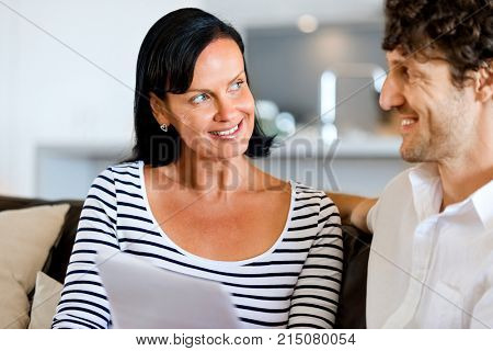 Couple with papers in their living room