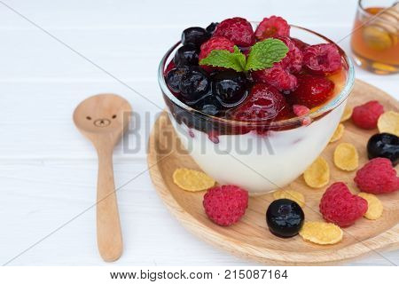 Yogurt, fruit and strawberry, raspberry, blueberry on old wood floor