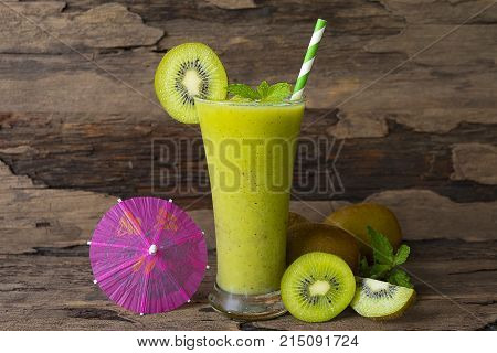 Kiwi Yogurt Healthy Fruit Smoothie Drink in the morning on an old wood background.