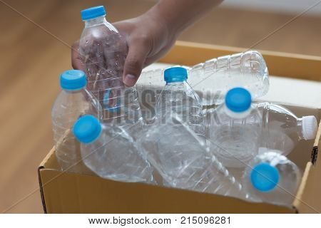 Man Hand Putting Plastic Reuse  For Recycling Concept Environmental Protection World Recycle