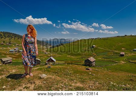 Young happy woman against mountain landscapes near Khulo village of Georgian Adjara region