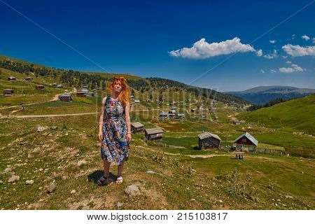 Young happy woman against mountain landscapes near Khulo village of Georgian Adjara region
