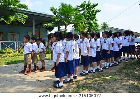 Thai Children Student Line Up At Front Of Classroom Building Of Don Moon (ngang) School