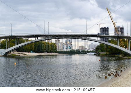 bridge over the river with ducks on the construction background