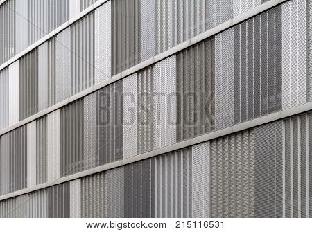full frame detail of a house facade cased with metallic perforated plates