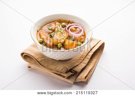 Aloo Gobi matar is a famous Indian curry dish with potatoes and cauliflower and green peas, selective focus