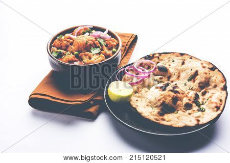 Aloo Gobi matar is a famous Indian curry dish with potatoes and cauliflower and green peas, selective focus