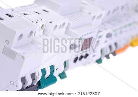 Various miniature circuit breakers and other devices on white background.