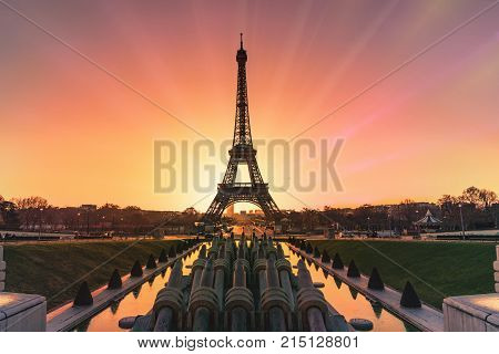 Early Morning Sunrise Behind And In The Middle Of The Eiffel Tower With The Reflection On The Founta