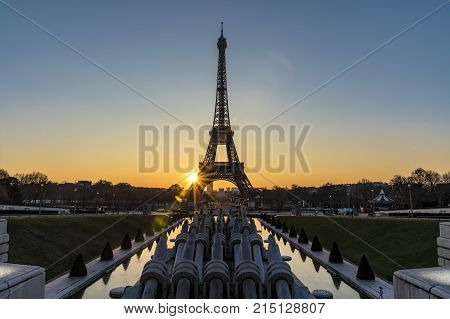 Early Morning Sunrise Behind And In The Middle Of The Eiffel Tower With The Reflection On The Founta