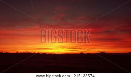 Beautiful vivid red orange sky during gorgeous sunrise.