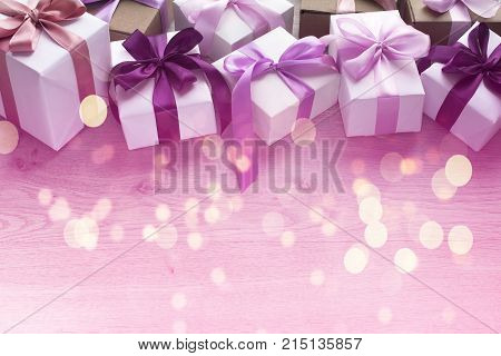 Gift boxes decorated with satin ribbon. The festive lights. Top view flat lay