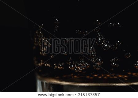 Close-Up Of Refreshing Glass Of Cola Fizzy Drink With Detailed Bubbles On Dark Background