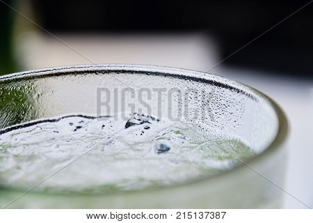 Close-Up Of Fresh Classic Mojito Cocktail In Glass With Ice Cubes