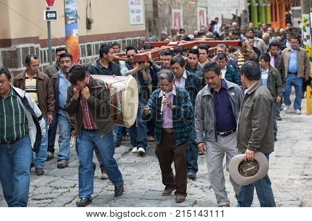 March 24, 2016 San Pedro la Laguna, Guatemala: men carrying a cross on the street of the Mayan town during Easter procession